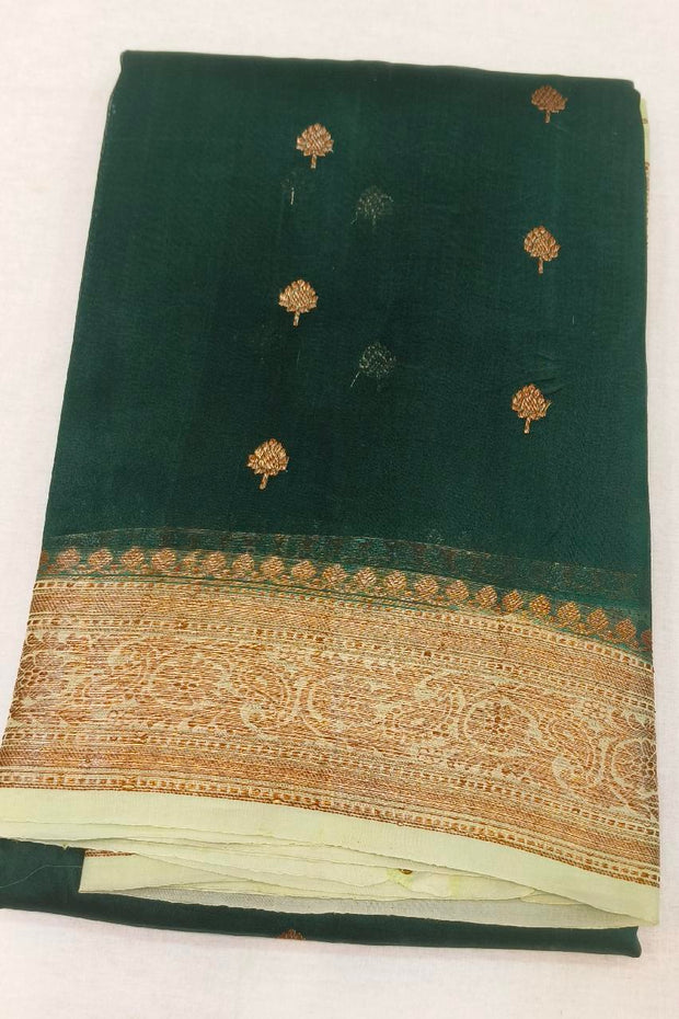 Banarasi kora ( organza) silk saree in bottle green with  gold motifs.