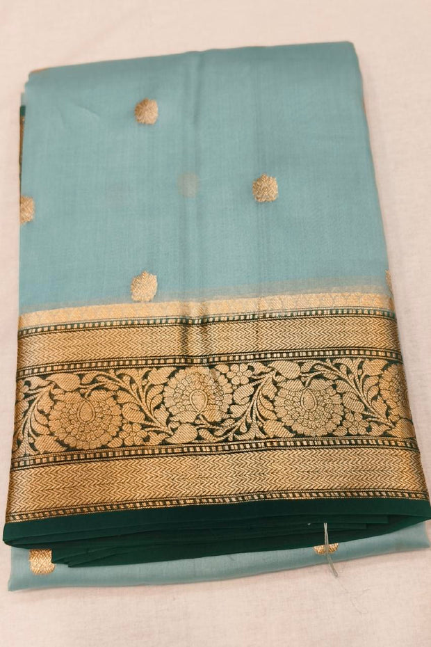 Banarasi kora ( organza) silk saree in sky blue with  gold motifs.