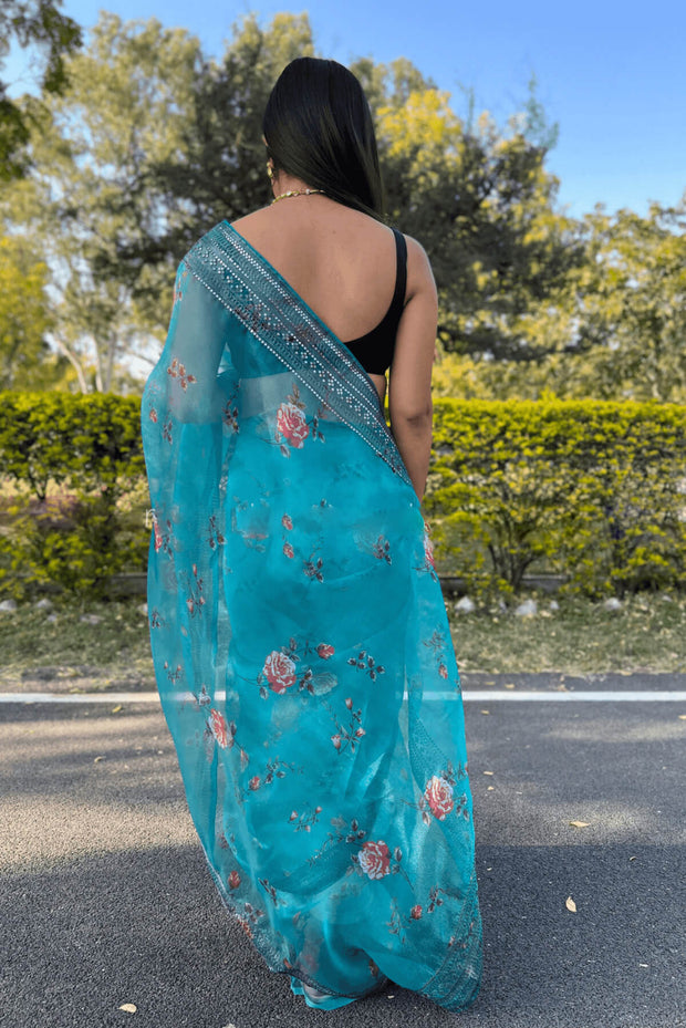 Printed organza saree in sea green with coding sequin work.