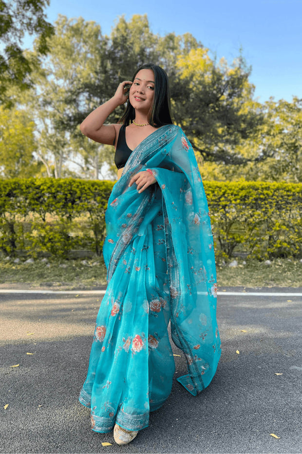 Printed organza saree in sea green with coding sequin work.