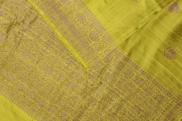 Handloom Banarasi katan pure silk saree in mehndi green in dupion finish with floral motifs .