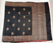 Handloom Banarasi katan pure silk saree in black in dupion finish with floral motifs .