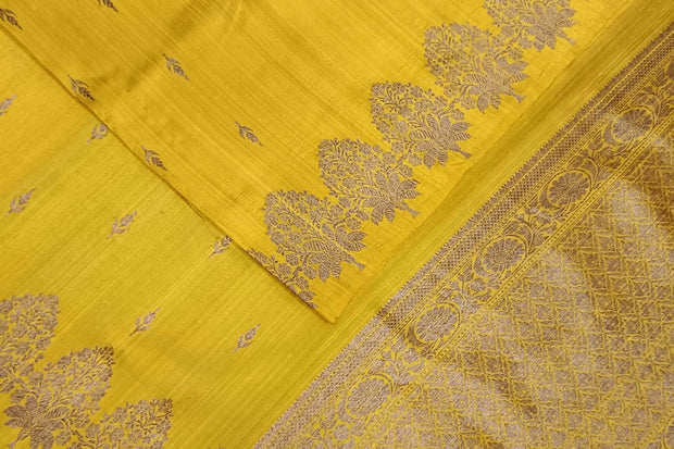 Handloom Banarasi katan pure silk saree in yellow in dupion finish with floral motifs.