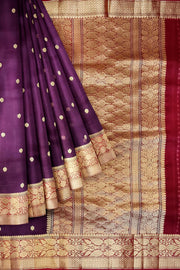 Banarasi kora ( organza) silk saree in purple with  gold motifs.