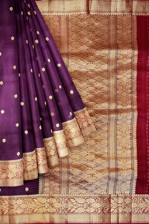 Banarasi kora ( organza) silk saree in purple with  gold motifs.