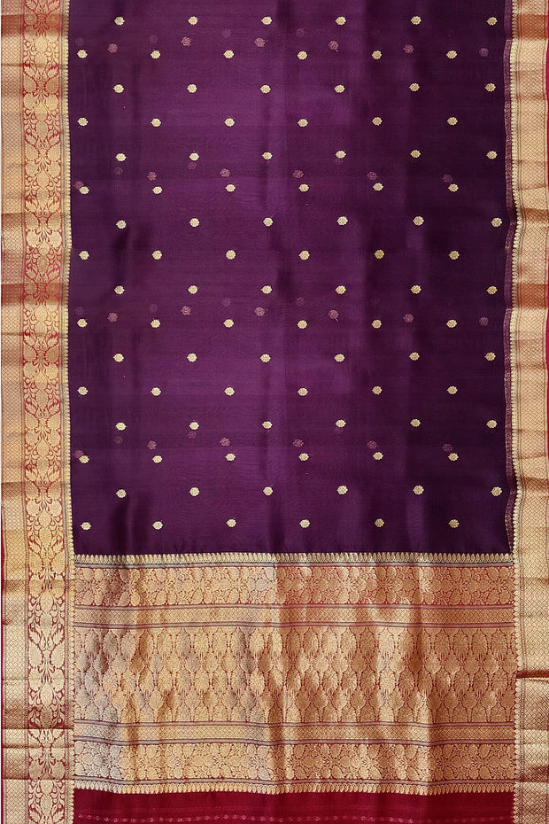 Banarasi kora ( organza) silk saree in purple with  gold motifs.