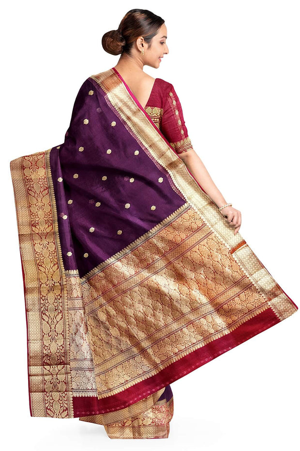 Banarasi kora ( organza) silk saree in purple with  gold motifs.