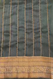 Banarasi kora ( organza) silk saree in gram green with  gold motifs.