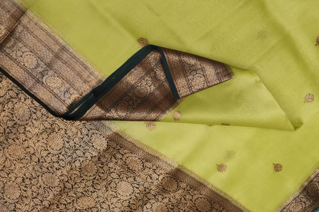 Banarasi kora ( organza) silk saree in gram green with  gold motifs.