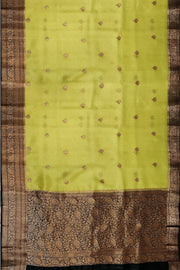 Banarasi kora ( organza) silk saree in gram green with  gold motifs.