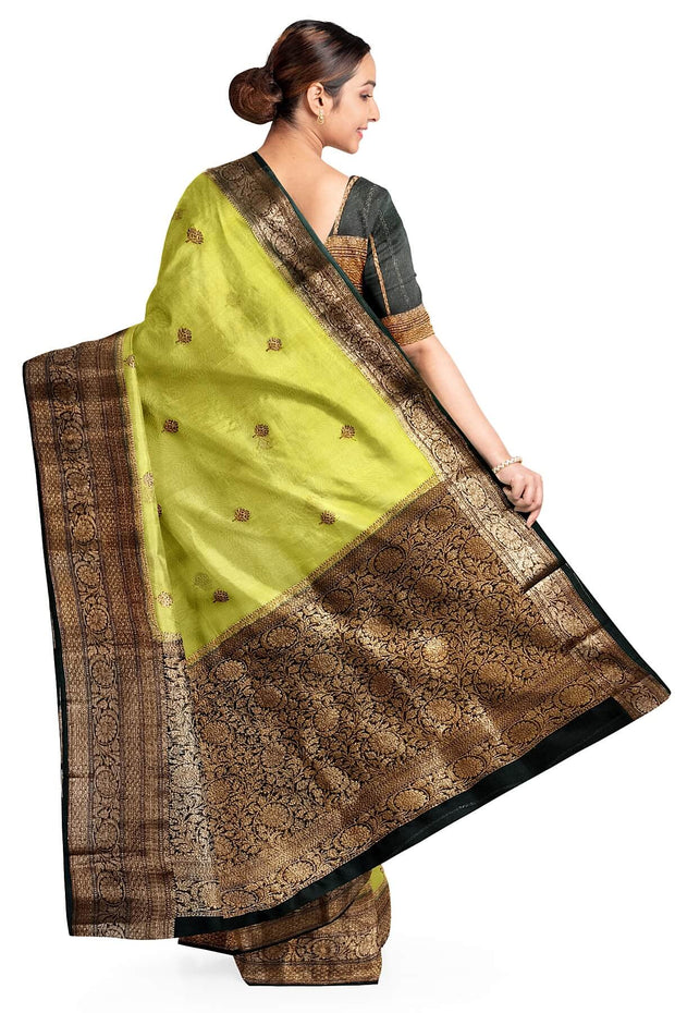 Banarasi kora ( organza) silk saree in gram green with  gold motifs.