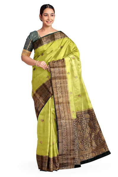 Banarasi kora ( organza) silk saree in gram green with  gold motifs.