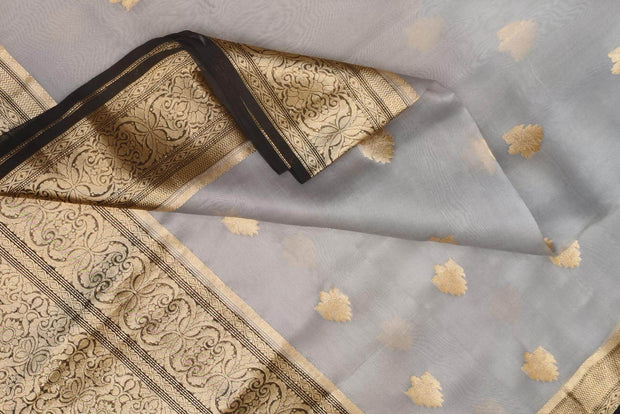 Banarasi kora ( organza) silk saree in grey with  gold motifs.