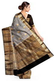 Banarasi kora ( organza) silk saree in grey with  gold motifs.