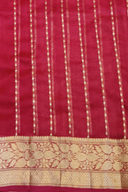 Banarasi kora ( organza) silk saree in red with  gold motifs.