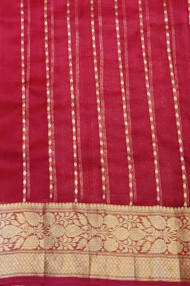 Banarasi kora ( organza) silk saree in red with  gold motifs.