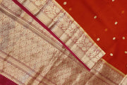 Banarasi kora ( organza) silk saree in red with  gold motifs.