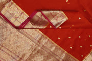 Banarasi kora ( organza) silk saree in red with  gold motifs.