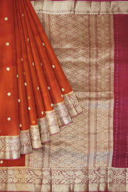 Banarasi kora ( organza) silk saree in red with  gold motifs.