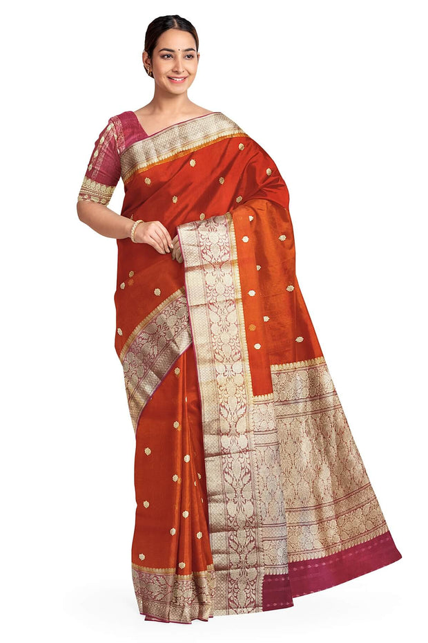 Banarasi kora ( organza) silk saree in red with  gold motifs.