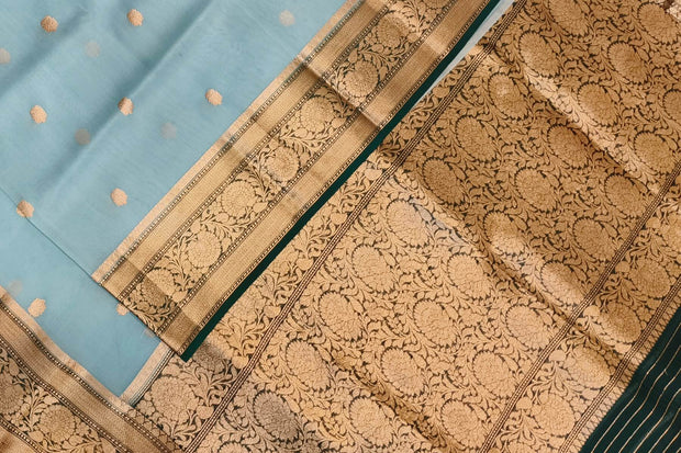 Banarasi kora ( organza) silk saree in sky blue with  gold motifs.