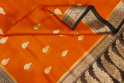 Banarasi kora ( organza) silk saree in orange with  gold motifs.