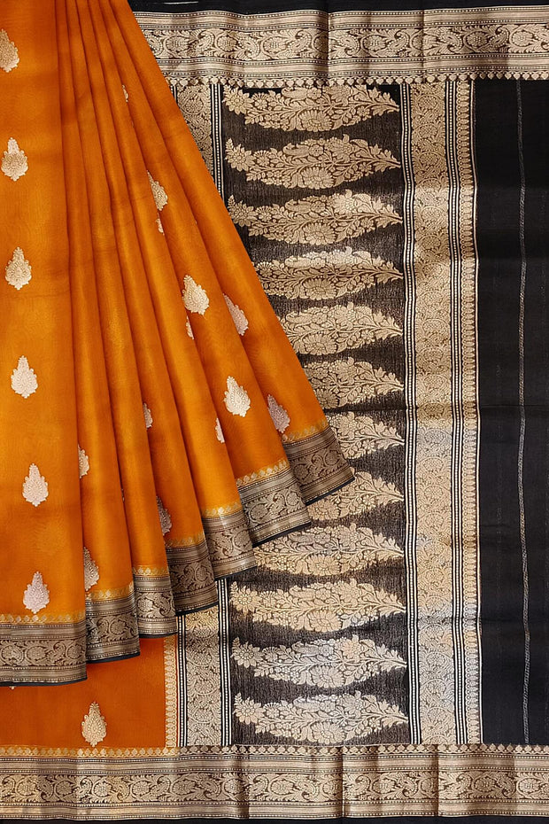 Banarasi kora ( organza) silk saree in orange with  gold motifs.