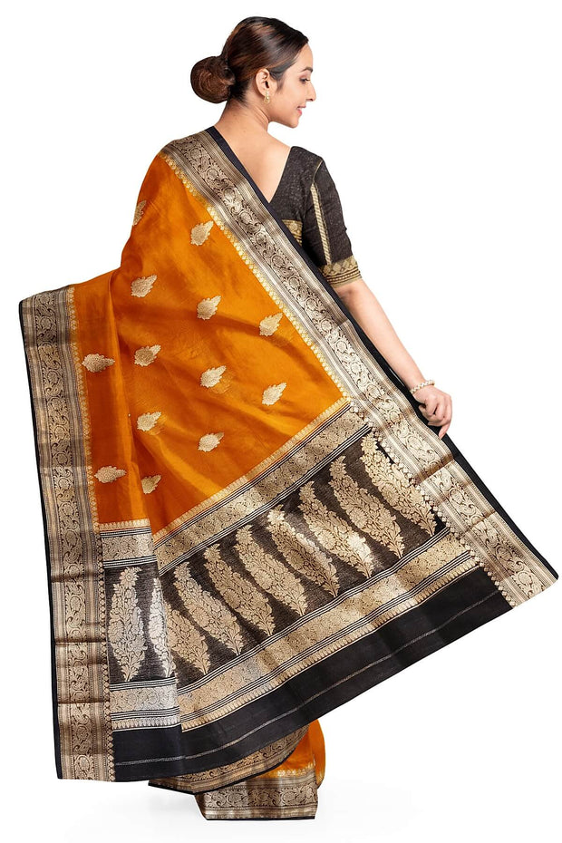 Banarasi kora ( organza) silk saree in orange with  gold motifs.