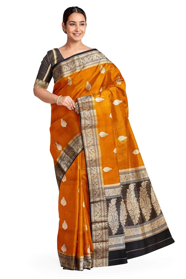 Banarasi kora ( organza) silk saree in orange with  gold motifs.