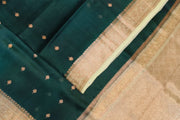 Banarasi kora ( organza) silk saree in bottle green with  gold motifs.