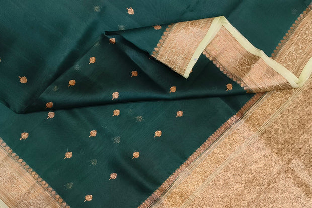 Banarasi kora ( organza) silk saree in bottle green with  gold motifs.