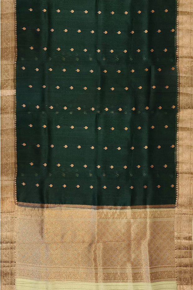 Banarasi kora ( organza) silk saree in bottle green with  gold motifs.