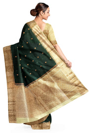 Banarasi kora ( organza) silk saree in bottle green with  gold motifs.