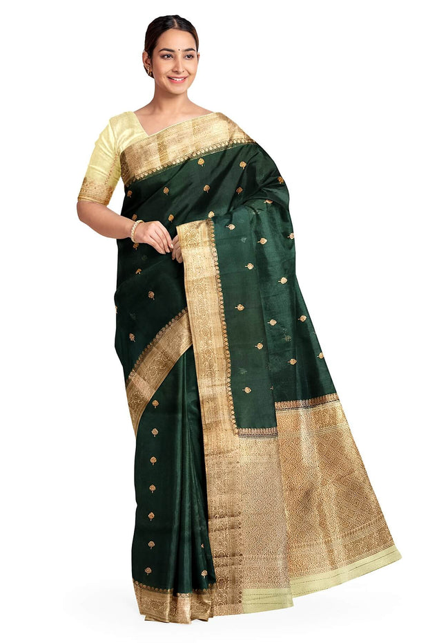 Banarasi kora ( organza) silk saree in bottle green with  gold motifs.