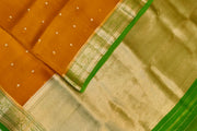 Banarasi kora ( organza) silk saree in mustard with  gold motifs.