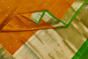 Banarasi kora ( organza) silk saree in mustard with  gold motifs.