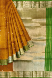 Banarasi kora ( organza) silk saree in mustard with  gold motifs.