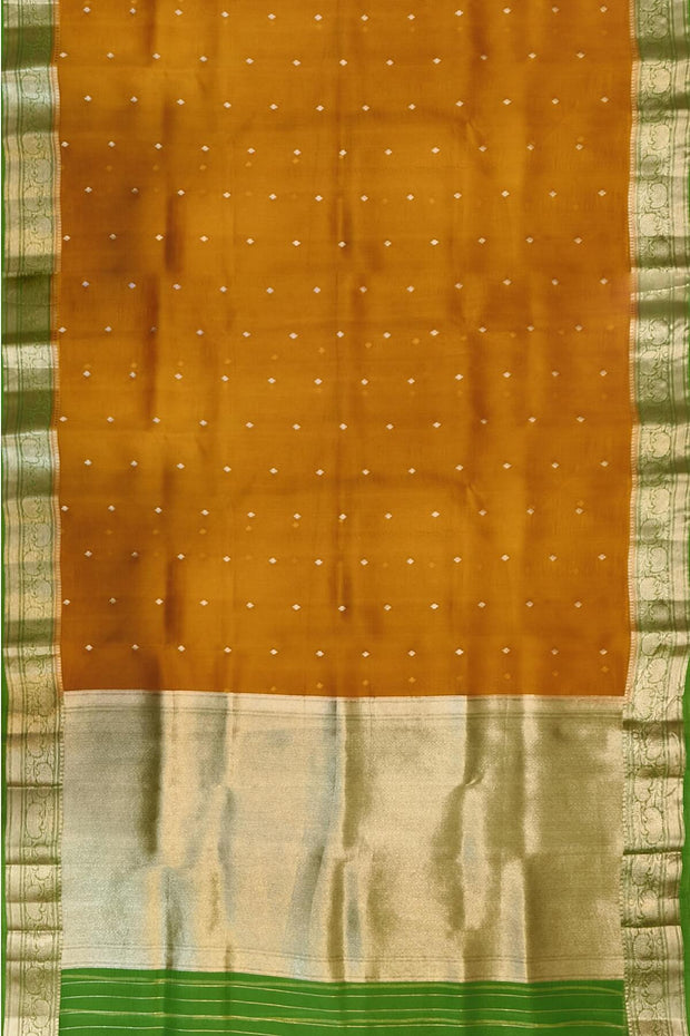 Banarasi kora ( organza) silk saree in mustard with  gold motifs.