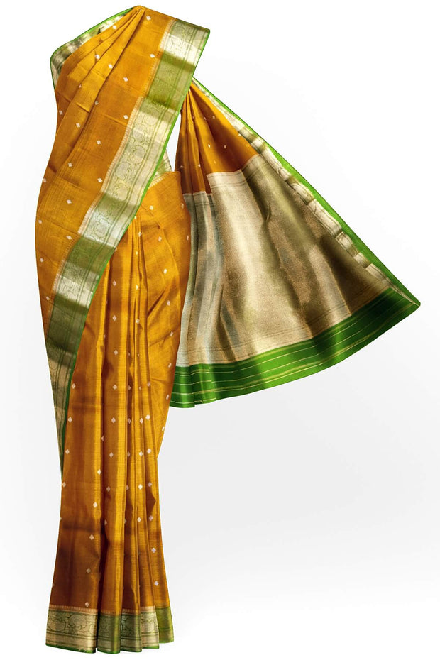 Banarasi kora ( organza) silk saree in mustard with  gold motifs.