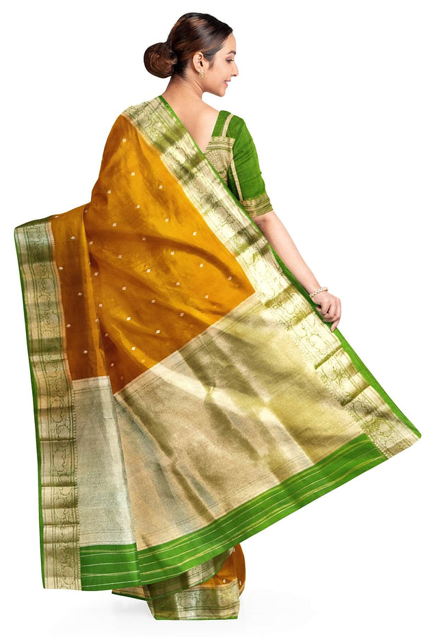 Banarasi kora ( organza) silk saree in mustard with  gold motifs.