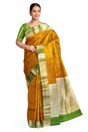 Banarasi kora ( organza) silk saree in mustard with  gold motifs.