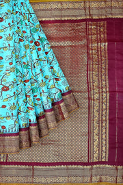 Handwoven Gadwal pure silk printed saree in  pool blue with floral vines .