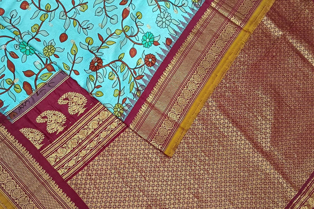 Handwoven Gadwal pure silk printed saree in  pool blue with floral vines .