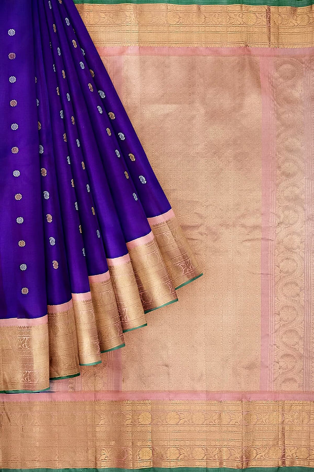 Handwoven Gadwal pure silk saree in purple with floral and paisley  motifs in gold & silver.