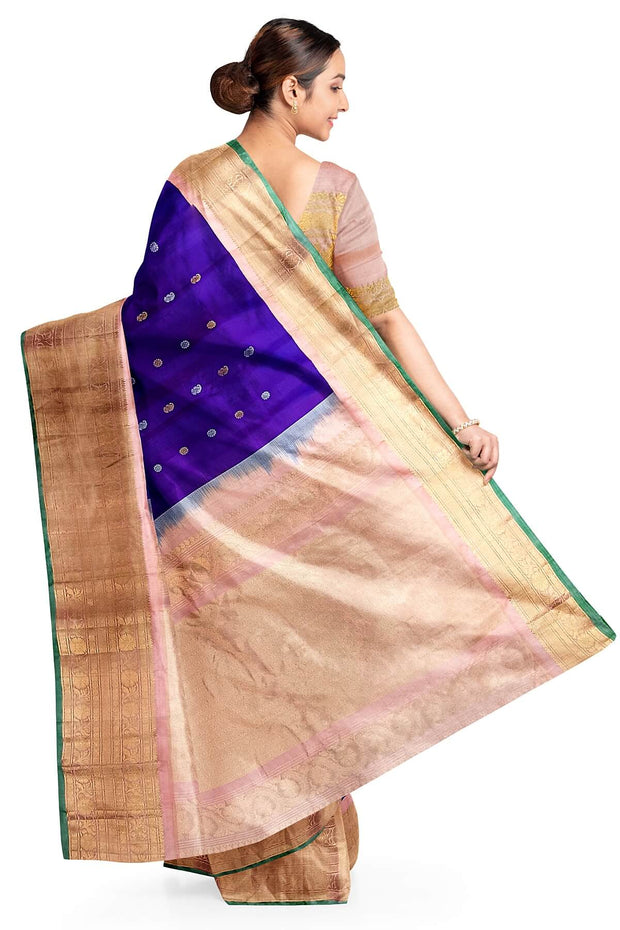 Handwoven Gadwal pure silk saree in purple with floral and paisley  motifs in gold & silver.