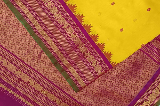 Handwoven Gadwal pure silk saree in yellow with floral   motifs in gold & magenta.