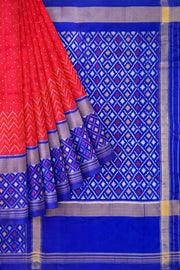 Handwoven Ikat pure silk saree in red with small motifs and a skirt border .