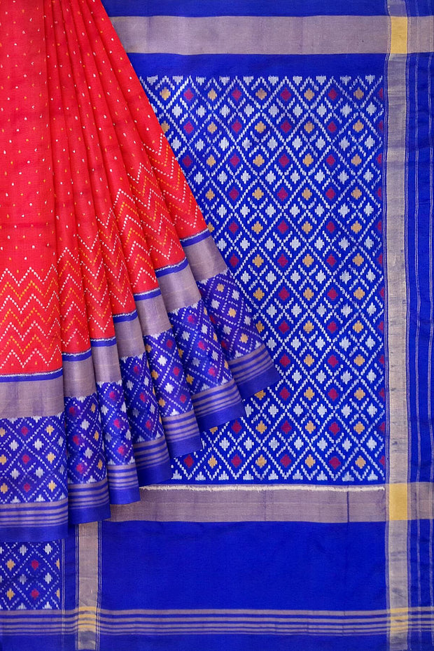 Handwoven Ikat pure silk saree in red with small motifs and a skirt border .
