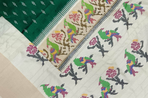 Handwoven ikat pure silk saree in dark green with small motifs