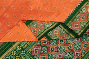 Handwoven ikat pure silk saree in coral orange with small motifs.